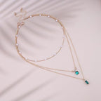 Emerald Glow Multilayer Pendant Necklace – Green Stone & Pearl (Gold Plated)
